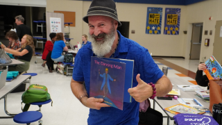  music teacher holding music book